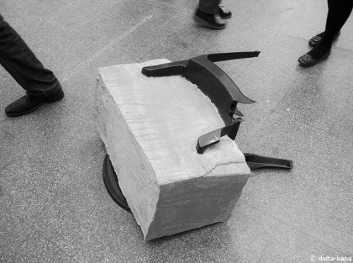 "How much does it take", mass concrete and plastic chair. Sculpture from Nina Nowak at the class of Prof. Richard Deacon. Rundgang 2011, Kunstakademie Düsseldorf